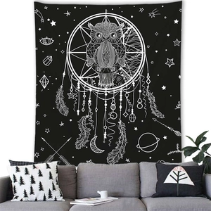 Detail of owl dreamcatcher wall tapestry hanging above a modern sofa in a cozy room