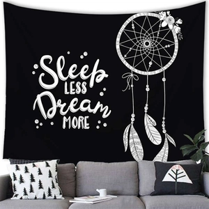 Black tapestry with white dreamcatcher and Sleep LESS Dream MORE quote in cozy living room