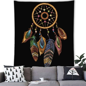 Detail of dreamcatcher tapestry with colorful feathers hanging over a living room sofa