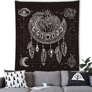 Detail of bohemian dreamcatcher tapestry with moon and crystals on a white wall