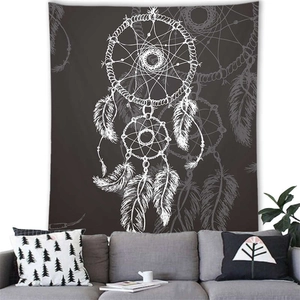 Dreamcatcher tapestry hanging above a grey sofa in a cozy interior living room
