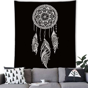 Detail view of a large black bohemian dreamcatcher tapestry hanging above a sofa in a living room