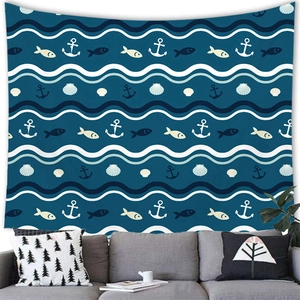 Marine nautical tapestry with anchor and fish pattern hanging above a gray sofa