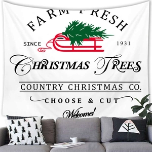 Detail of Christmas wall tapestry featuring a red sleigh and tree over a grey sofa