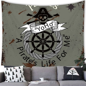 Detail of pirate anchor skull tapestry on a modern living room wall with a grey sofa