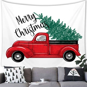 Merry Christmas tapestry with vintage red truck and green tree over a grey sofa