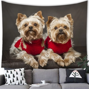 Detail of wall tapestry featuring two Yorkshire Terriers in red sweaters over a gray sofa