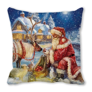 Detail of Christmas pillow featuring Santa feeding a reindeer in a snowy forest scene