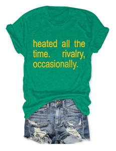 Flat lay of a green crewneck T-shirt with yellow text and distressed blue denim shorts