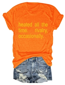 Detail of orange crew neck t-shirt with slogan and distressed denim shorts set