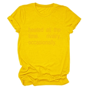 Detail of crew neck yellow t-shirt with heated all the time slogan and rolled sleeves