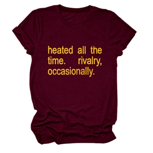 Detail of burgundy crew neck t-shirt featuring yellow 'heated all the time' printed text