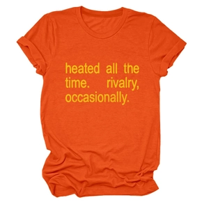 Detail of orange crew neck T-shirt featuring yellow 'heated all the time' graphic text