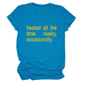 Close-up of peacock blue cotton T-shirt featuring yellow printed text and rolled sleeves