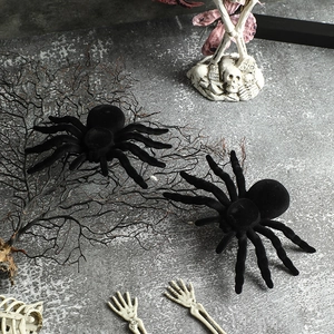 Black flocked Halloween spiders set on a graveyard scene with skulls and RIP stones