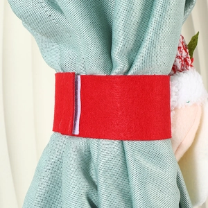 Christmas curtain tieback with red felt strap and festive knitted ornaments for decor