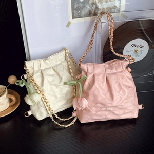 Quilted leather bucket bags in pink and white with golden chain and tulip charms