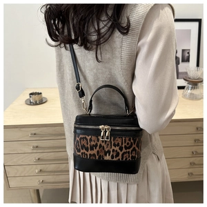 Chic leopard print crossbody bag styled with a minimalist outfit in a cozy home setting