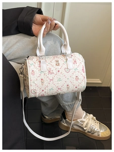 Detail of white bucket bag with cute bear and ice cream prints and textured finish