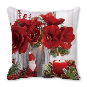 Christmas cushion with red amaryllis, Santa ornament and candles on white background