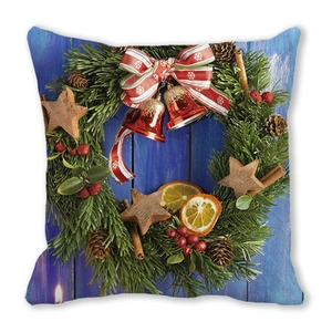 Christmas wreath cushion cover with bells and berries on blue wood texture background