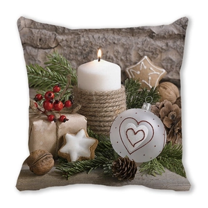 Close-up of peach skin cushion cover with festive Christmas prints and fine textures