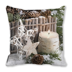 Detailed view of Christmas pillow cover with candles, pine cones, and snowy branches