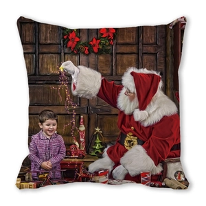 Detail of soft peach skin cushion cover featuring a Santa Claus and child holiday print