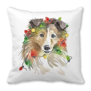 Detailansicht von Sheltie-Aquarelldruck mit Weihnachtslichtern auf weichem Kissen