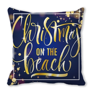 Detail of Christmas pillow cover featuring golden Christmas on the Beach text on blue