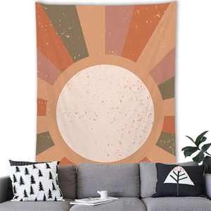 Close-up of geometric sunburst tapestry with retro warm tones over a gray sofa