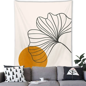 Nordic Morandi style tapestry with gingko leaf and sun hanging over a grey modern sofa