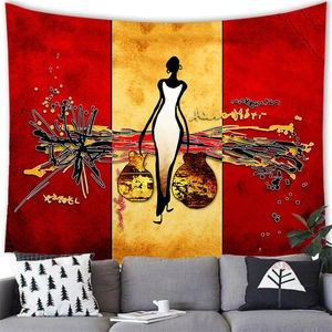 Detailed view of abstract African woman wall tapestry hung above a modern gray sofa