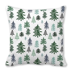Detailed close-up of Christmas pine tree patterns on white fabric pillow cover