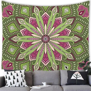Bohemian mandala tapestry with green and pink radial pattern on white wall background