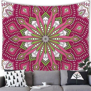 Detailed mandala tapestry with red and green patterns hanging above a sofa in a living room