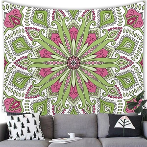 Bohemian mandala wall tapestry with green and pink radial pattern above a grey sofa