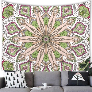 Detailed scene of a geometric mandala tapestry in pink and green hanging above a sofa