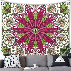 Detail of bohemian mandala tapestry hanging on wall above a grey sofa in a modern room