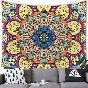 Detail of bohemian mandala tapestry featuring vibrant radial patterns above a modern sofa