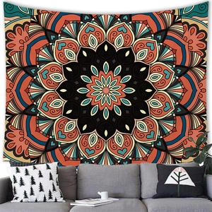 Exotic geometric mandala tapestry with cyan and orange patterns above a modern grey sofa
