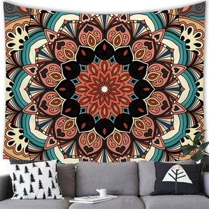 Detailed mandala tapestry with geometric patterns hanging over a modern grey sofa