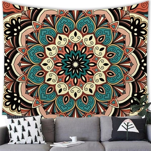 Detail of geometric mandala tapestry with orange and blue floral motifs in living room
