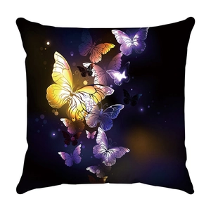 Detail of soft plush cushion cover featuring luminous butterfly print on black background