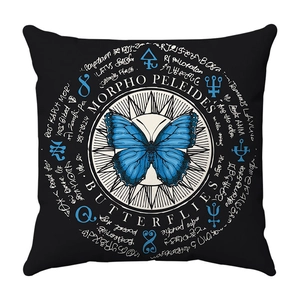 Detail of blue Morpho butterfly print and vintage occult symbols on black cushion cover