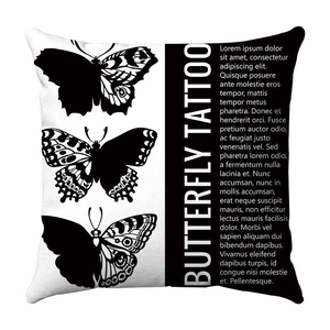 Close-up of square cushion cover with black butterfly tattoo prints and typography