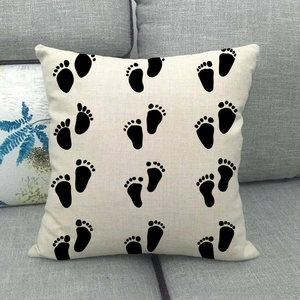 Linen square pillow cover with black paw print pattern on beige fabric for sofa decor