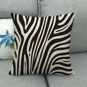 Detail shot of black zebra pattern linen pillowcase on a grey sofa with fabric texture