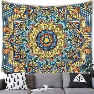 Bohemian mandala wall tapestry with blue and red geometric radial pattern over a sofa