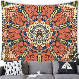 Close-up of mandala wall tapestry with orange geometric patterns in a cozy living room